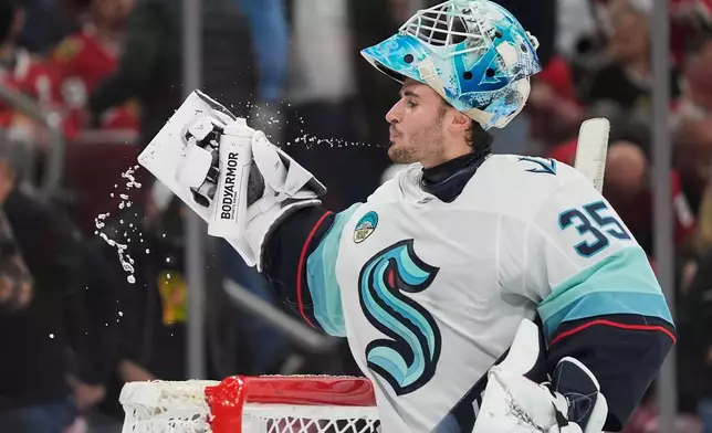 Seattle Kraken goaltender Joey Daccord (35) spits water during the second period of an NHL hockey game against the Chicago Blackhawks, Thursday, Nov. 20, 2025, in Chicago. (AP Photo/Erin Hooley)
