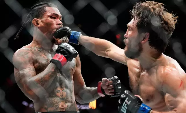 Ethyn Ewing, right, punches Malcolm Wellmaker, left, during the second round of a featherweight bout at the UFC 322 mixed martial arts event, Saturday, Nov. 15, 2025, in New York. (AP Photo/Yuki Iwamura)