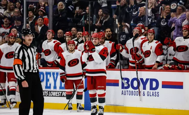 Carolina Hurricanes' Nikolaj Ehlers (27), formerly of the Winnipeg Jets, greets the fans during a tribute to him in the first period of an NHL hockey game against the Jets in Winnipeg, Manitoba, Friday, Nov. 21, 2025. (John Woods/The Canadian Press via AP)