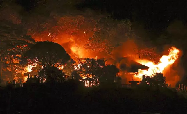 Flames rise from the site of a fire in Oita, southern Japan Tuesday, Nov. 18, 2025. (Kyodo News via AP)
