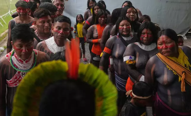 EDS NOTE: NUDITY - An Indigenous group attends the opening ceremony of the People's Summit offsite from the COP30 U.N. Climate Summit, Wednesday, Nov. 12, 2025, in Belem, Brazil. (AP Photo/Fernando Llano)