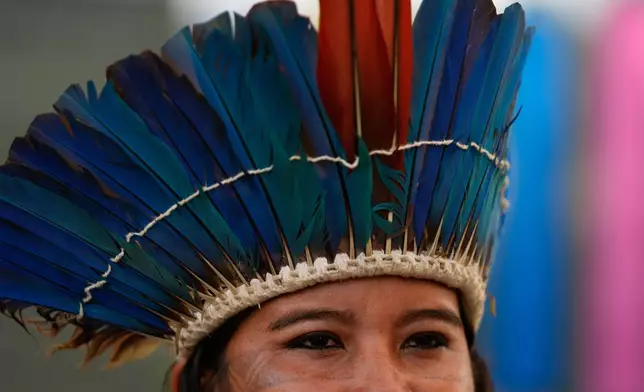 An Indigenous person sings and dances as they participate in an opening ceremony as part of the People's Summit offsite from the COP30 U.N. Climate Summit, Wednesday, Nov. 12, 2025, in Belem, Brazil. (AP Photo/Fernando Llano)