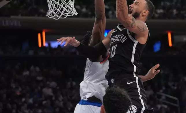 Brooklyn Nets' Tyrese Martin (13) drives past New York Knicks' Og Anunoby and Landry Shamet (44) during the second half of an NBA basketball game Sunday, Nov. 9, 2025, at Madison Square Garden in New York. (AP Photo/Frank Franklin II)