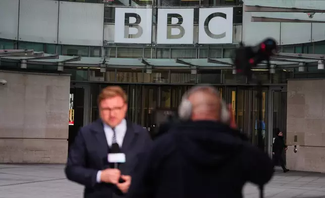 Journalists report outside BBC Broadcasting House in London, Tuesday, Nov. 11, 2025. (AP Photo/Kirsty Wigglesworth)