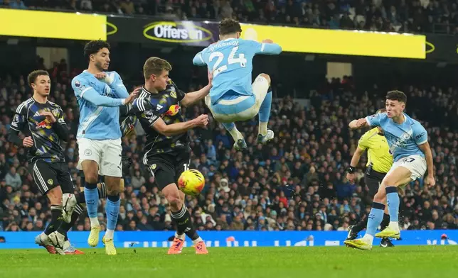 Manchester City's Phil Foden, right, scores during the English Premier League soccer match between Manchester City and Leeds United in Manchester, England, Saturday, Nov. 29, 2025. (AP Photo/Ian Hodgson)