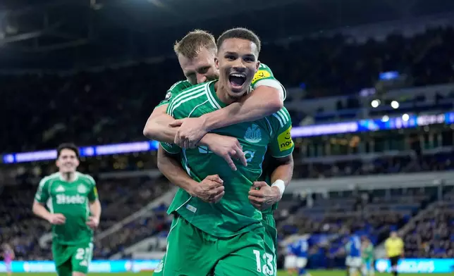 Newcastle United's Malick Thiaw celebrates after scoring his sides fourth goal during the English Premier League soccer match between Everton and Newcastle United in Liverpool, England, Saturday Nov. 29, 2025. (Peter Byrne/PA via AP)