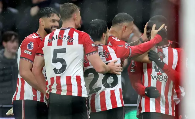 Sunderland's Brian Brobbey, right, celebrates scoring their side's third goal of the game during the English Premier League soccer match between Sunderland and Bournemouth in Sunderland, England, Saturday Nov. 29, 2025. (Steve Welsh/PA via AP)
