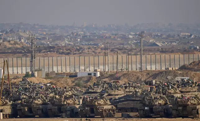 Israeli tanks are parked in a staging area near the border with Gaza, in southern Israel, Tuesday, Nov. 18, 2025. (AP Photo/Ohad Zwigenberg)