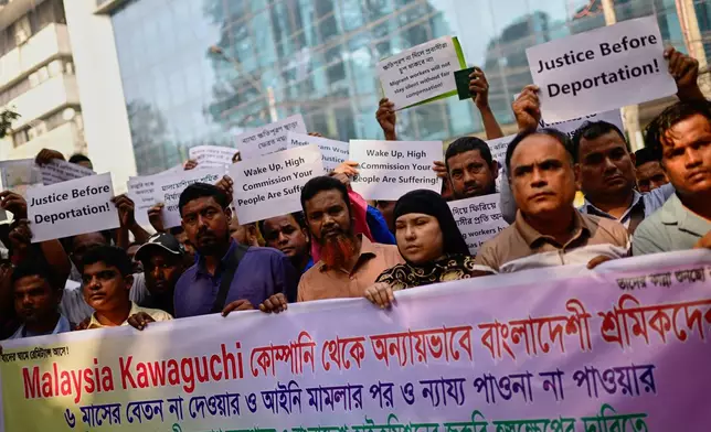 Bangladeshi workers who were employed by Malaysian companies protest in front of the Ministry of Expatriates' Welfare and Overseas Employment demanding unpaid wages, fair compensation and an end to alleged abuse by Malaysian employers, in Dhaka, Bangladesh, Monday, Nov. 10, 2025. (AP Photo/Mahmud Hossain Opu)