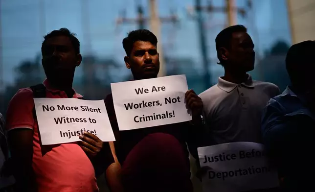 Bangladeshi workers who were employed by Malaysian companies hold banners during a protest in front of the Ministry of Expatriates' Welfare and Overseas Employment demanding unpaid wages, fair compensation and an end to alleged abuse by Malaysian employers, in Dhaka, Bangladesh, Monday, Nov. 10, 2025. (AP Photo/Mahmud Hossain Opu)