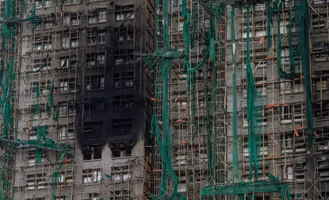 Burned buildings are seen at the scene of the fire that started Wednesday at Wang Fuk Court, a residential estate in the Tai Po district of Hong Kong's New Territories, Friday, Nov. 28, 2025. (AP Photo/Chan Long Hei)