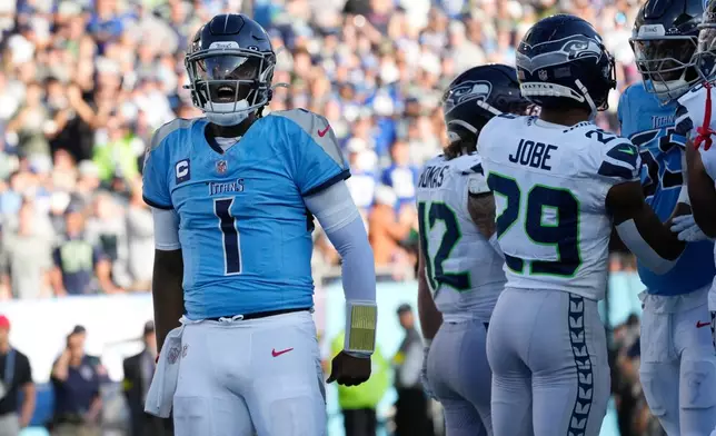 Tennessee Titans quarterback Cam Ward (1) celebrates after scoring a touchdown against the Seattle Seahawks during the second half of an NFL football game Sunday, Nov. 23, 2025, in Nashville, Tenn. (AP Photo/George Walker IV)