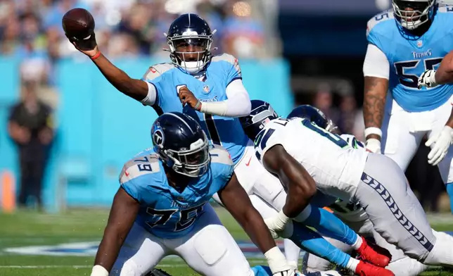 Tennessee Titans quarterback Cam Ward (1) gets a completed pass away during the first half of an NFL football game against the Seattle Seahawks Sunday, Nov. 23, 2025, in Nashville, Tenn. (AP Photo/George Walker IV)