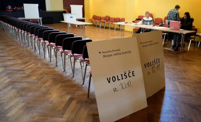 Commission wait for voters at a polling station during the referendum on assisted dying for terminally ill patients, in Domzale, Slovenia, Sunday, Nov. 23, 2025. (AP Photo/Darko Bandic)