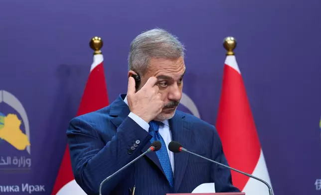 Turkish Foreign Minister Hakan Fidan, listens to his Iraqi counterpart Fuad Hussein during a news conference after a meeting at the foreign ministry in Baghdad, Iraq, Sunday, Nov. 2, 2025. (AP Photo/Hadi Mizban)