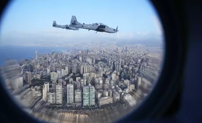 Two Lebanese air force fighters escort Pope Leo XIV's plane as it flies over Beirut, Lebanon, on it's way to the international airport, Sunday, Nov. 30, 2025. (AP Photo/Domenico Stinellis)
