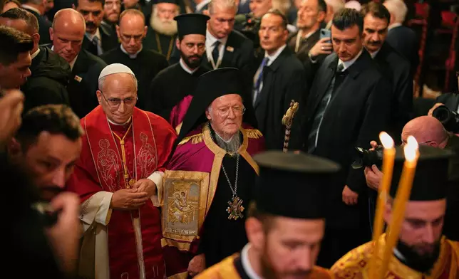 Pope Leo XIV and Ecumenical Patriarch Bartholomew I, the spiritual leader of the world's Eastern Orthodox Christians leave after attending the Doxology at the Patriarchal Church of Saint George, in Istanbul, Turkey, Saturday, Nov. 29, 2025. (AP Photo/Emrah Gurel)