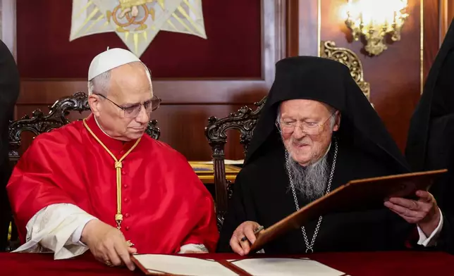 Pope Leo XIV and Ecumenical Patriarch Bartholomew I sign a joint declaration at the Ecumenical Patriarchate, during Pope's first apostolic journey, in Istanbul, Turkey, November 29, 2025. (Dilara Senkaya/Pool Via AP)