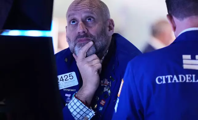 Trader Meric Greenbaum works on the floor of the New York Stock Exchange, Friday, Nov. 21, 2025. (AP Photo/Richard Drew)
