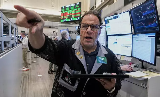 Options trader Anthony Spina works on the floor of the New York Stock Exchange, Friday, Nov. 21, 2025. (AP Photo/Richard Drew)