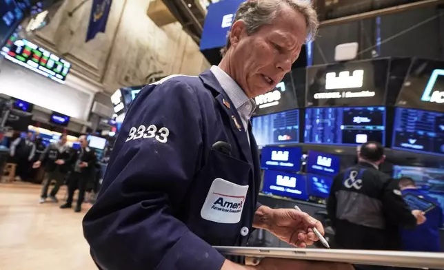 Trader Robert Charmak works on the floor of the New York Stock Exchange, Monday, Nov. 24, 2025. (AP Photo/Richard Drew)
