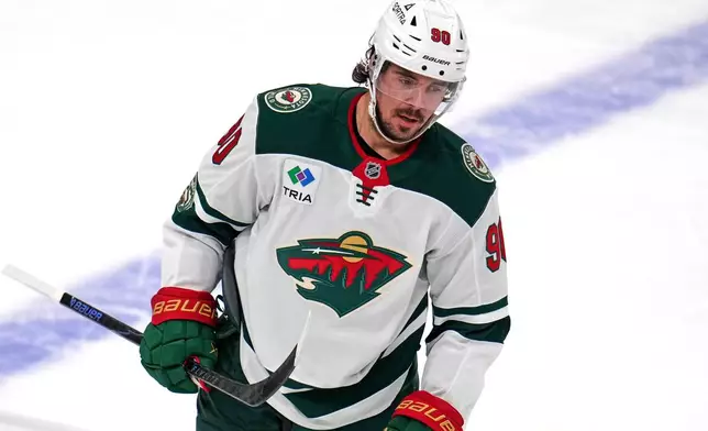 Minnesota Wild's Marcus Johansson returns to his bench after scoring during the first period of an NHL hockey game against the Pittsburgh Penguins in Pittsburgh, Friday, Nov. 21, 2025. (AP Photo/Gene J. Puskar)