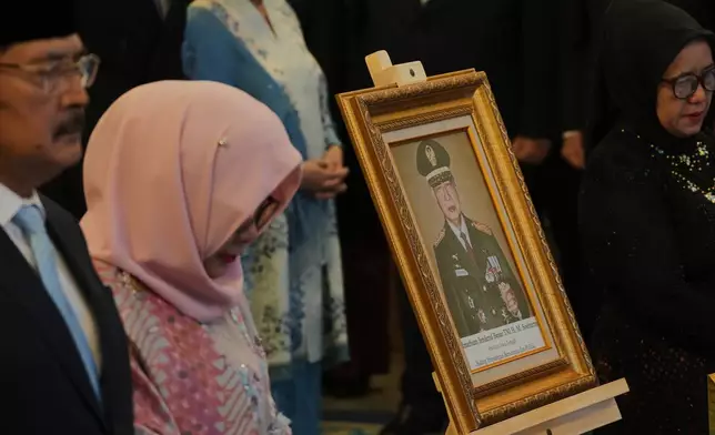 A portrait of the late President Suharto is displayed during a ceremony awarding national hero title to ten figures including the former strongman, at the State Palace in Jakarta, Indonesia, Monday, Nov. 10, 2025. (AP Photo/Achmad Ibrahim)