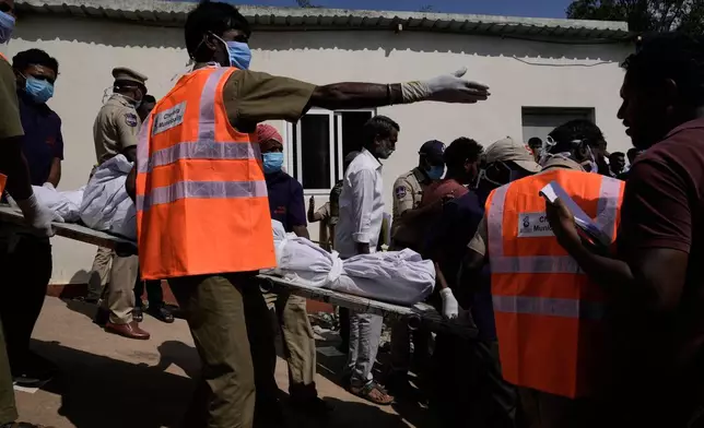 CAPTION CORRECTS THE LOCATION - Municipal workers carry a victim of the fatal passenger bus accident in Chevella in southern state of Telangana, India, Monday, Nov. 3, 2025. (AP Photo/Mahesh Kumar A.)