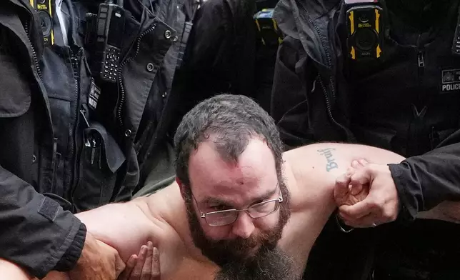 FILE - Police officers detain a protester outside the Home Office during a Palestine Action demonstration in London, Nov. 24, 2025. (AP Photo/Kirsty Wigglesworth, File)