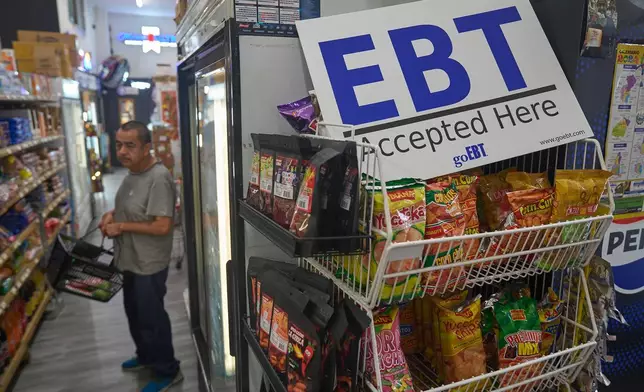 FILE - A banner reads: "EBT (Electronic Benefit Transfer) Accepted Here," at El Recuerdo Market in Los Angeles, Oct. 31, 2025, after two federal judges ordered President Donald Trump's administration to continue funding SNAP during the government shutdown. (AP Photo/Damian Dovarganes, file)