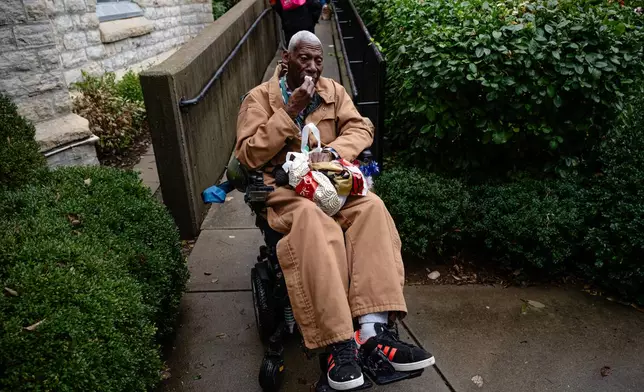 FILE - Brock Brooks, a disable Marine Corps veteran, cries while describing the impending SNAP shutdowns while waiting in line to enter the food pantry service at Calvary Episcopal Church on Oct. 30, 2025, in Louisville, Ky. (AP Photo/Jon Cherry, file)