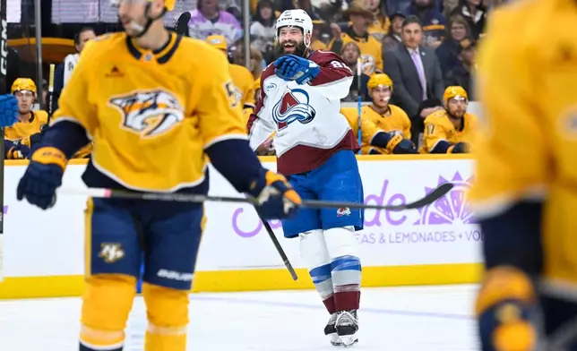 Colorado Avalanche defenseman Brent Burns, center, reacts after scoring against the Nashville Predators during the first period of an NHL hockey game Saturday, Nov. 22, 2025, in Nashville, Tenn. (AP Photo/John Amis)