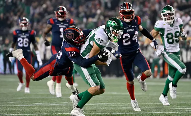 Saskatchewan Roughriders' Tommy Nield (83) gets taken down by Montreal Alouettes' Najee Murray (12) after running 34 yards to the Montreal one-yard line for first down during second half CFL football action in the Grey Cup in Winnipeg, Manitoba, Sunday, Nov. 16, 2025. (Fred Greenslade/The Canadian Press via AP)