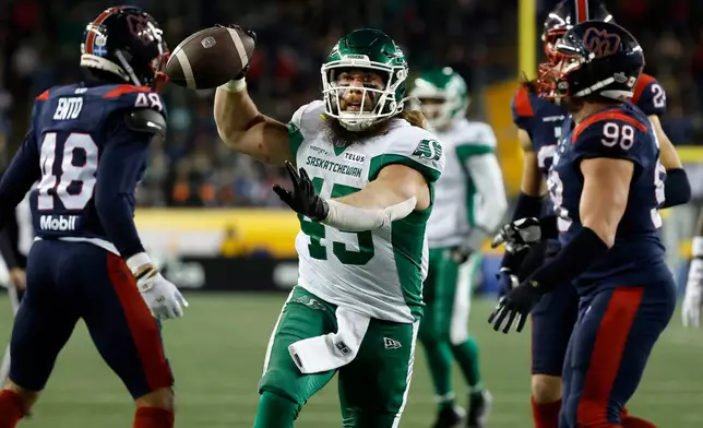 Saskatchewan Roughriders' A.J. Ouellette (45) celebrates his touchdown against the Montreal Alouettes during first half CFL football action in the Grey Cup in Winnipeg, Manitoba, Sunday, Nov. 16, 2025. (John Woods/The Canadian Press via AP)