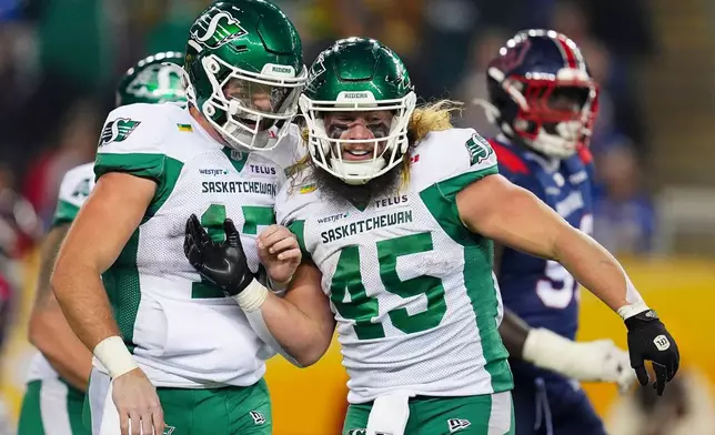 Saskatchewan Roughriders quarterback Tommy Stevens (17) celebrates his touchdown with teammate A.J. Ouellette (45) against the Montreal Alouettes during second half CFL football action in the Grey Cup in Winnipeg, Manitoba, Sunday, Nov. 16, 2025. (Frank Gunn/The Canadian Press via AP)