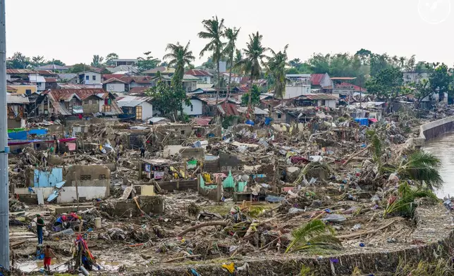 In this photo provided by the Malacanang Presidential Communications Office, damaged homes beside Mananga Bridge in Talisay, Cebu Province, central Philippines on Friday Nov. 7, 2025 after Typhoon Kalmaegi devastated the province and claimed lives. (Malacanang Presidential Communications Office via AP)