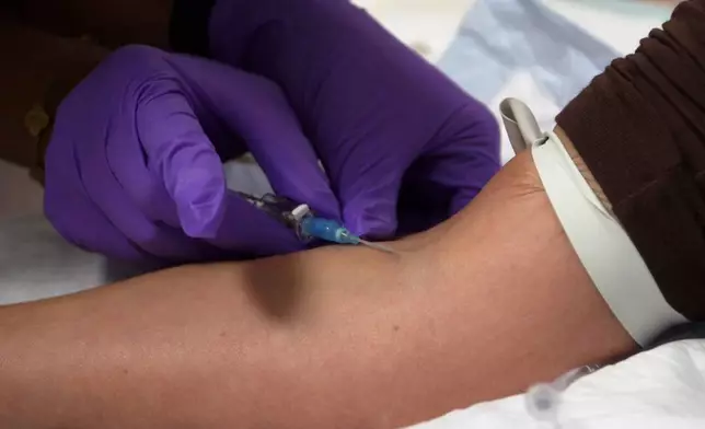 In this image taken from video, an IV infusion is administered at Pure Alchemy Wellness, Tuesday, Nov. 11, 2025, in Chula Vista, Calif. (AP Photo/Javier Arciga)