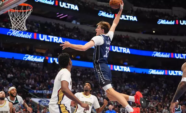 Dallas Mavericks forward Cooper Flagg (32) comes in for slam dunk against the New Orleans Pelicans during the second half of an NBA Cup basketball game in Dallas, Friday, Nov. 21, 2025. (AP Photo/LM Otero)