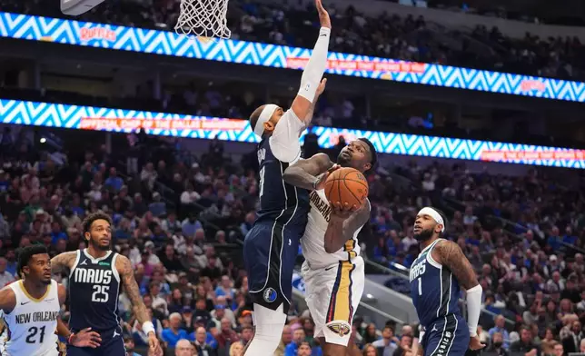 New Orleans Pelicans forward Zion Williamson (1) tries to score against Dallas Mavericks forward Daniel Gafford (21) as Pelicans center Yves Missi (21) looks on with Mavericks defenders P.J. Washington (25) and Jaden Hardy (1) during the first half of an NBA Cup basketball game in Dallas, Friday, Nov. 21, 2025. (AP Photo/LM Otero)