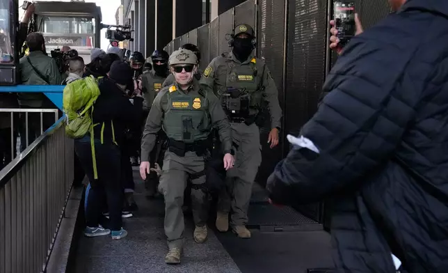 U.S. Customs and Border Patrol agents arrive to escort U.S. Customs and Border Patrol Gregory Bovino from federal court in Chicago, Tuesday, Oct. 28, 2025. (AP Photo/Nam Y. Huh)