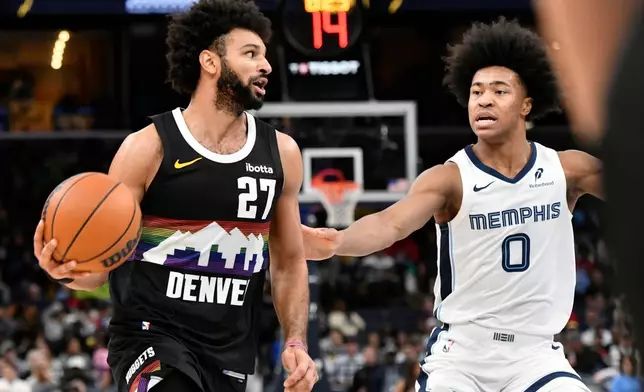 Denver Nuggets guard Jamal Murray (27) handles the ball against Memphis Grizzlies forward Jaylen Wells (0) in the second half of an NBA basketball game Monday, Nov. 24, 2025, in Memphis, Tenn. (AP Photo/Brandon Dill)