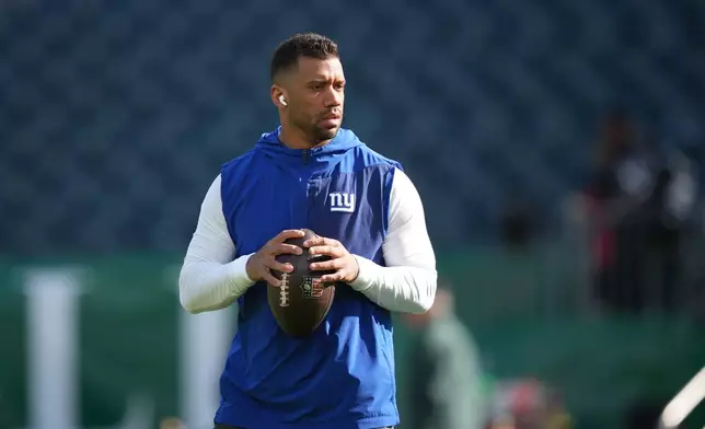 FILE - New York Giants' Russell Wilson warms up before an NFL football game against the Philadelphia Eagles, Oct. 26, 2025, in Philadelphia. (AP Photo/Matt Slocum, File)