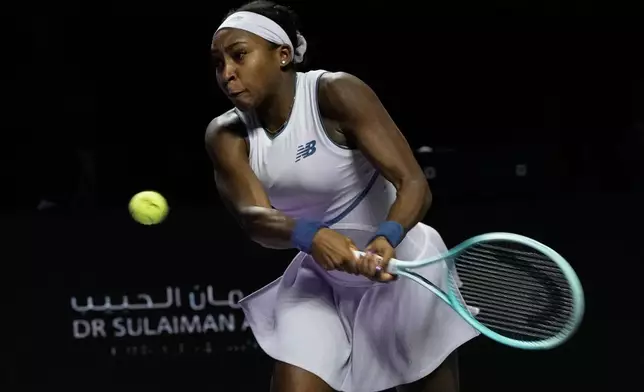 Coco Gauff of the United States plays a backhand return to Aryna Sabalenka of Belarus during their women's singles match at the WTA tennis finals in Riyadh, Saudi Arabia, Thursday, Nov. 6, 2025. (AP Photo/Fatima Shbair)