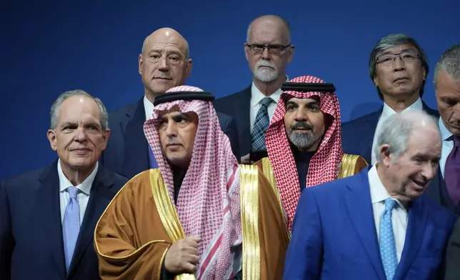 Saudi Investment Forum participants stand together before they are photographed as a group with President Donald Trump and Saudi Arabia's Crown Prince Mohammed bin Salman at the Kennedy Center, Wednesday, Nov. 19, 2025, in Washington. (AP Photo/Evan Vucci)