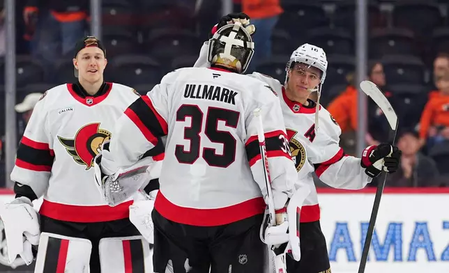 Ottawa Senators' Tim Stützle, right, celebrates an overtime win with goaltender Linus Ullmark (35) following an NHL hockey game against the Philadelphia Flyers, Saturday, Nov. 8, 2025, in Philadelphia. (AP Photo/Derik Hamilton)
