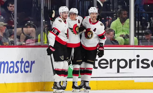 Ottawa Senators' Tim Stützle, center, celebrates his game wining goal with Drake Batherson (19) and Thomas Chabot (72) during overtime in an NHL hockey game against the Philadelphia Flyers, Saturday, Nov. 8, 2025, in Philadelphia. (AP Photo/Derik Hamilton)