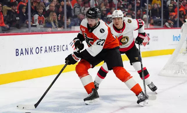 Philadelphia Flyers' Noah Cates, left, skates the puck past Ottawa Senators' Jordan Spence during the second period of an NHL hockey game, Saturday, Nov. 8, 2025, in Philadelphia. (AP Photo/Derik Hamilton)