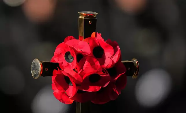 Poppies are seen on a cross during the Remembrance Sunday Service at the Cenotaph in London, Sunday, Nov. 9, 2025.(AP Photo/Alastair Grant, Pool)
