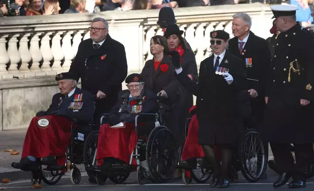 Veterans arrive at the beginning of the Remembrance Sunday ceremony at The Cenotaph on Whitehall in London, Sunday Nov. 9, 2025. (Toby Melville/Pool Photo via AP)