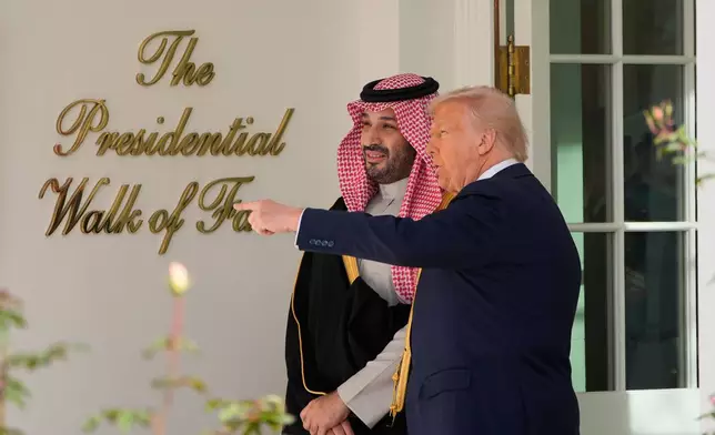 President Donald Trump walks with Saudi Arabia's Crown Prince Mohammed bin Salman along the colonnade, at the White House, Tuesday, Nov. 18, 2025, in Washington. (AP Photo/Alex Brandon)